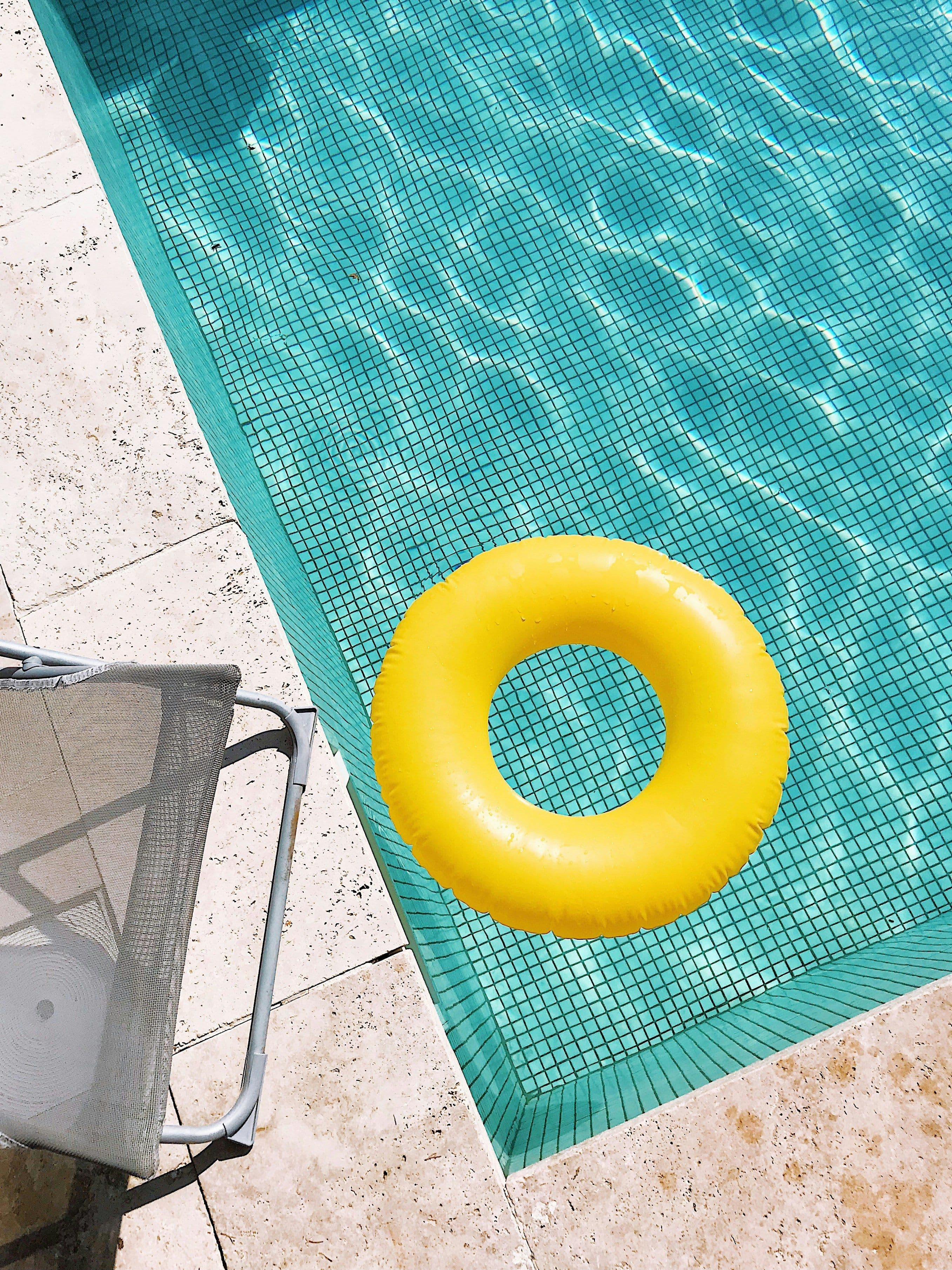 Crane lifting a pool shell for installation